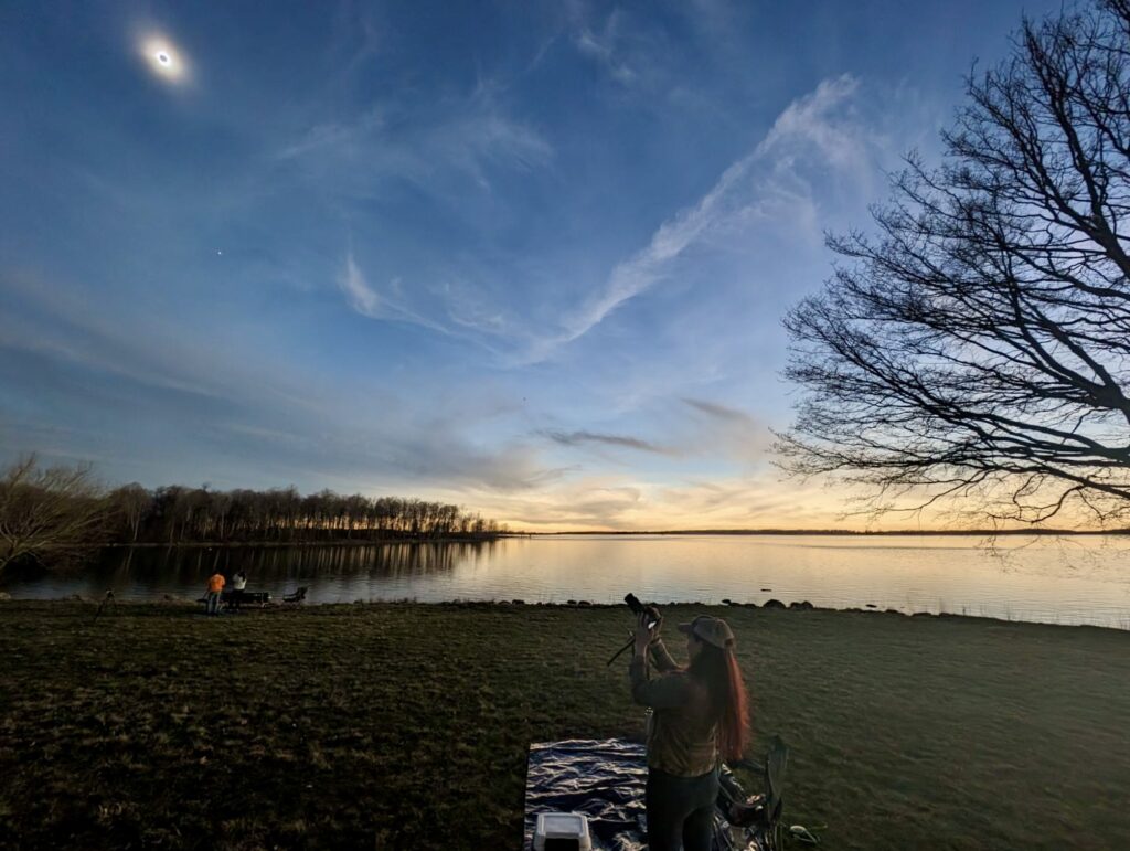 Katie Brittle taking a photo of the eclipse in Barnhart Island, in Massena New york