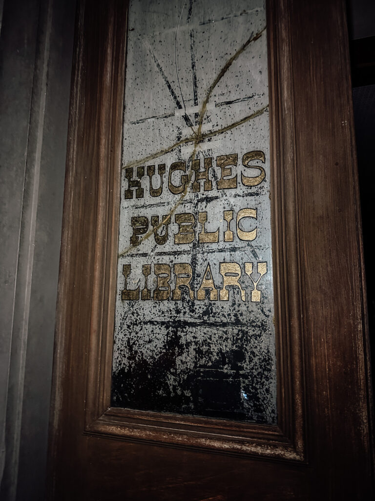 Hughes Public Library window at night in Rugby, Tennessee. One of the buildings that gives Haunted Rugby its name.